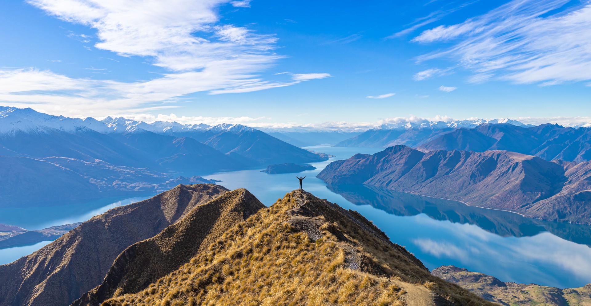 Asian traveler celebrating success at Roy's Peak Lake Wanaka New Zealand Asian traveler celebrating success at Roy's Peak Lake Wanaka New Zealand